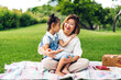 © Art_Photo - Portrait of happy asian grandmother and little asian cute girl enjoy relax in summer park.Young girl with their laughing grandparent smiling together.Family and togetherness
