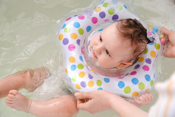 Poster - Mother and cute baby with inflatable ring in bathroom