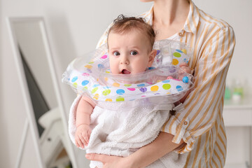 Canvas Print - Woman and cute baby with inflatable ring at home