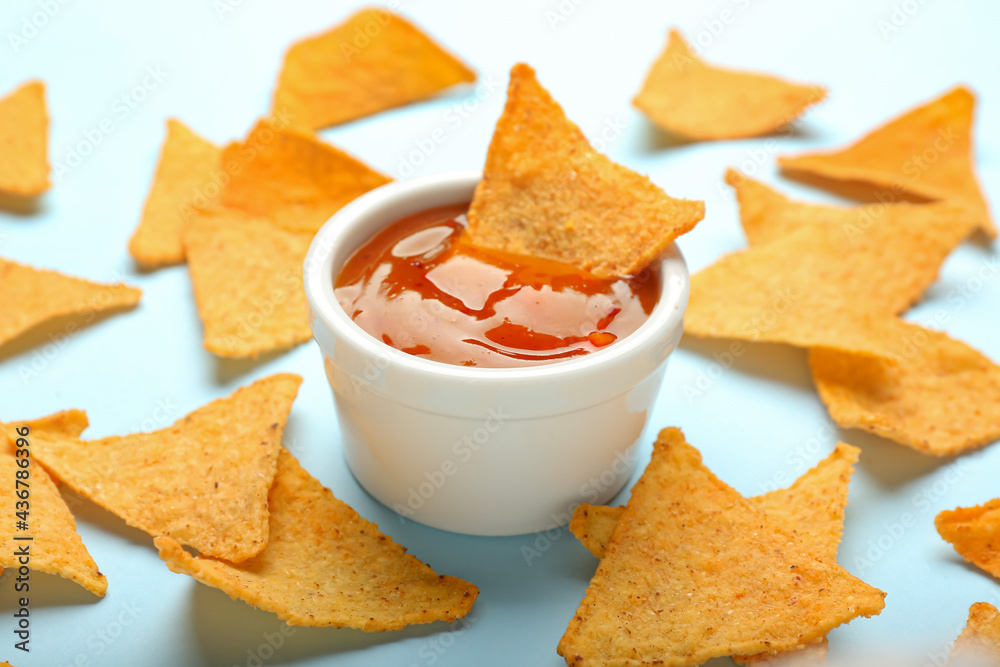 Tasty nachos with sauce on color background, closeup
