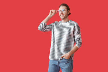 Sticker - Young man wearing eyeglasses on color background