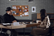 © Pixel-Shot - Young woman hiring a private detective for crime investigation