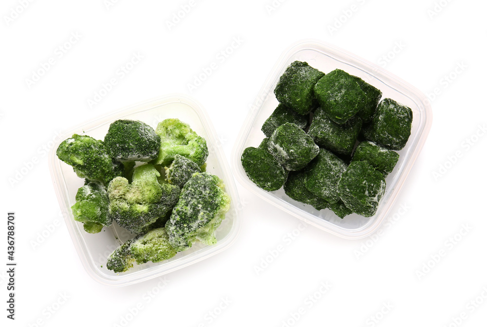Plastic containers with frozen broccoli and spinach on white background