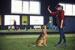 © Svitlana - Female instructor training a canine with a hand signal