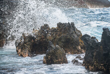 Splashing Waves On The Rock In The Sea. Wave Hit The Stone In The Ocean With A Water Background.
