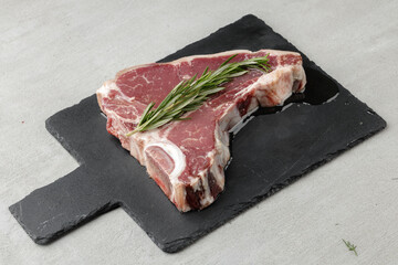 Wall Mural - Raw t-bone steak marinated in oil on gray table