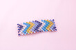 Colorful hair clip on pink background.