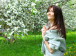 Beautiful woman with cherry flowers in spring garden 