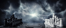 Chess Pieces On A Chessboard Against The Backdrop Of A Stormy Sky And Flashing Lightning. The Game Of Chess As A Symbol Of Strategy, Leadership, Tactics And Business Victories. 