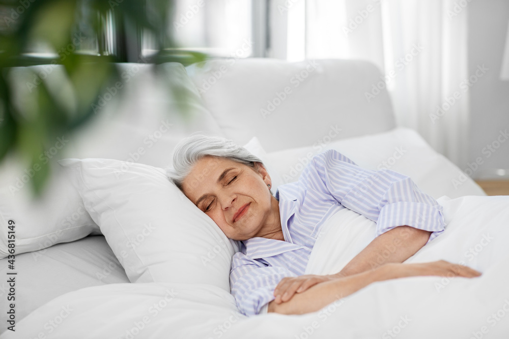 old age and people concept - senior woman sleeping in bed at home bedroom - obrazy, fototapety, plakaty 