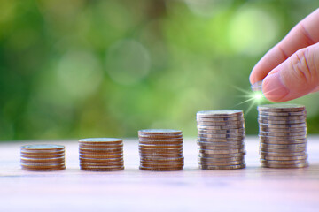 Poster - saving money concept, stacking coins with globe on table background, Advertising coins of finance and banking, business growth concept