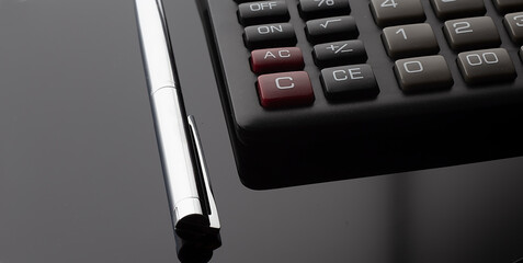 Poster - Office desk table with calculator and pen. Top view with copy space