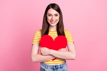 Sticker - Photo of cute young teen lady hug paper heart wear orange t-shirt isolated on pastel pink color background