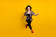 © deagreez - Full body photo of happy nice active young woman jump up runner sale isolated on yellow color background