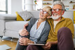 © NDABCREATIVITY - Happy romantic senior couple hugging and enjoying retirement at home