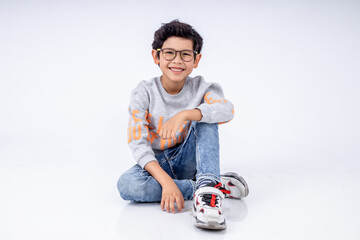 boy sitting on the floor in white studio and isolate