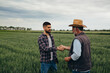 © cherryandbees - man handshake on wheat field