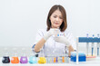 © EduLife Photos - A young woman researcher, doctor, scientist, or laboratory assistant working with plastic medical tubes to research, examine scientific experiments in a modern laboratory. Education stock photo