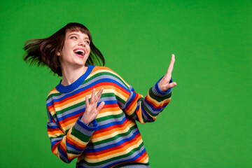 Sticker - Photo of charming nice young happy dream funky woman look empty space dance isolated on green color background