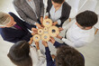 © Studio Romantic - Team of business people connect cogwheels as metaphor for good teamwork and work efficiency, high angle, from above. Senior and young entrepreneurs form an alliance and organize parts into one system