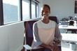 © Wavebreak Media - Smiling african american businesswoman sitting at desk at work