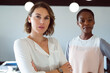© Wavebreak Media - Two diverse businesswomen standing with arms crossed at work