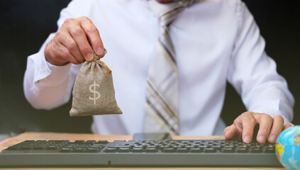Poster - Businessman hand holding money bag with saving money concept,advertising coins of finance and banking