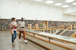 © AnnaStills - Blurred motion of people walking along the corridor in big library