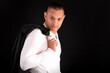 © blanke1973 - a young handsome man wears a black jacket and a white T-shirt on a black background