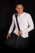 © blanke1973 - a young handsome man in a white sweatshirt with a black sports bag