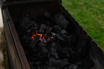 the process of lighting charcoal in the grill