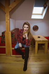 Wall Mural - Young lady with blonde hair wearing a red shirt and posing