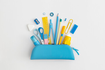 Pencil case with school stationery on a grey background. Top view. Flat lay. Back to school concept.