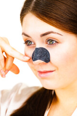 Wall Mural - Woman applying pore strips on nose