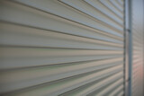 Fototapeta  - The surface of the blinds on the shop windows. Refracted plastic surface.