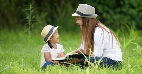 Wall Mural - Mom and daughter reading a book