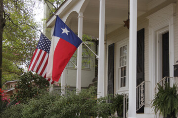 Historic Home With Texas and American Flags