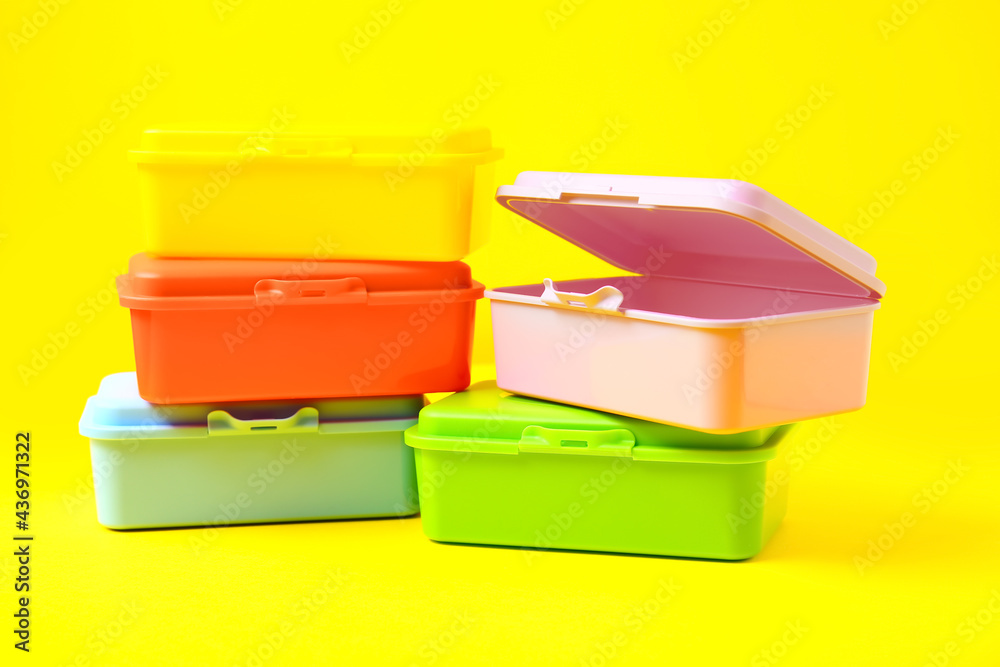 Plastic lunch boxes on color background