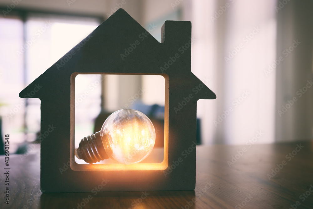 Wood house with Light bulb. energy concept or invention - obrazy, fototapety, plakaty 
