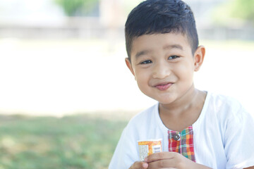 Cute Asian child little Thai boy 2 year old smile make a happy face concept. 