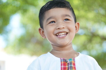 Cute Asian child little Thai boy 2 year old smile make a happy face concept. 