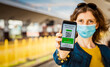 © Melinda Nagy - health Vaccine Passport for Coronavirus or Covid-19. Traveller Using Mobile Phone with Vaccination in Immune Status to Certificated International Traveling in train station