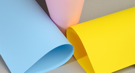 Poster - abstract background of curled sheets of multicolored paper with a shadow