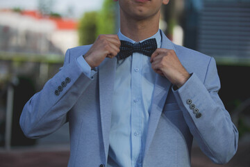 Wall Mural - Elegant man in a suit holding his bow