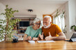 © bnenin - Senior husband, trying to help his wife with work.