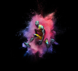 Wall Mural - One young sportsman basketball player in explosion of colored neon powder isolated on black background