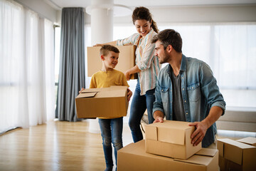 Wall Mural - Happy family with cardboard boxes in new house at moving day.