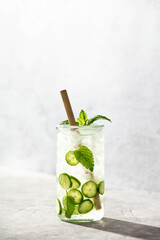 Delicious refreshing water with mint and cucumber with hard light and shadows