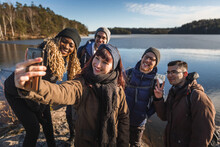 Company Of Multiracial Friends Taking Selfie On Smartphone