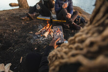Anonymous Black Woman Photographing Fire During Camping With Friends